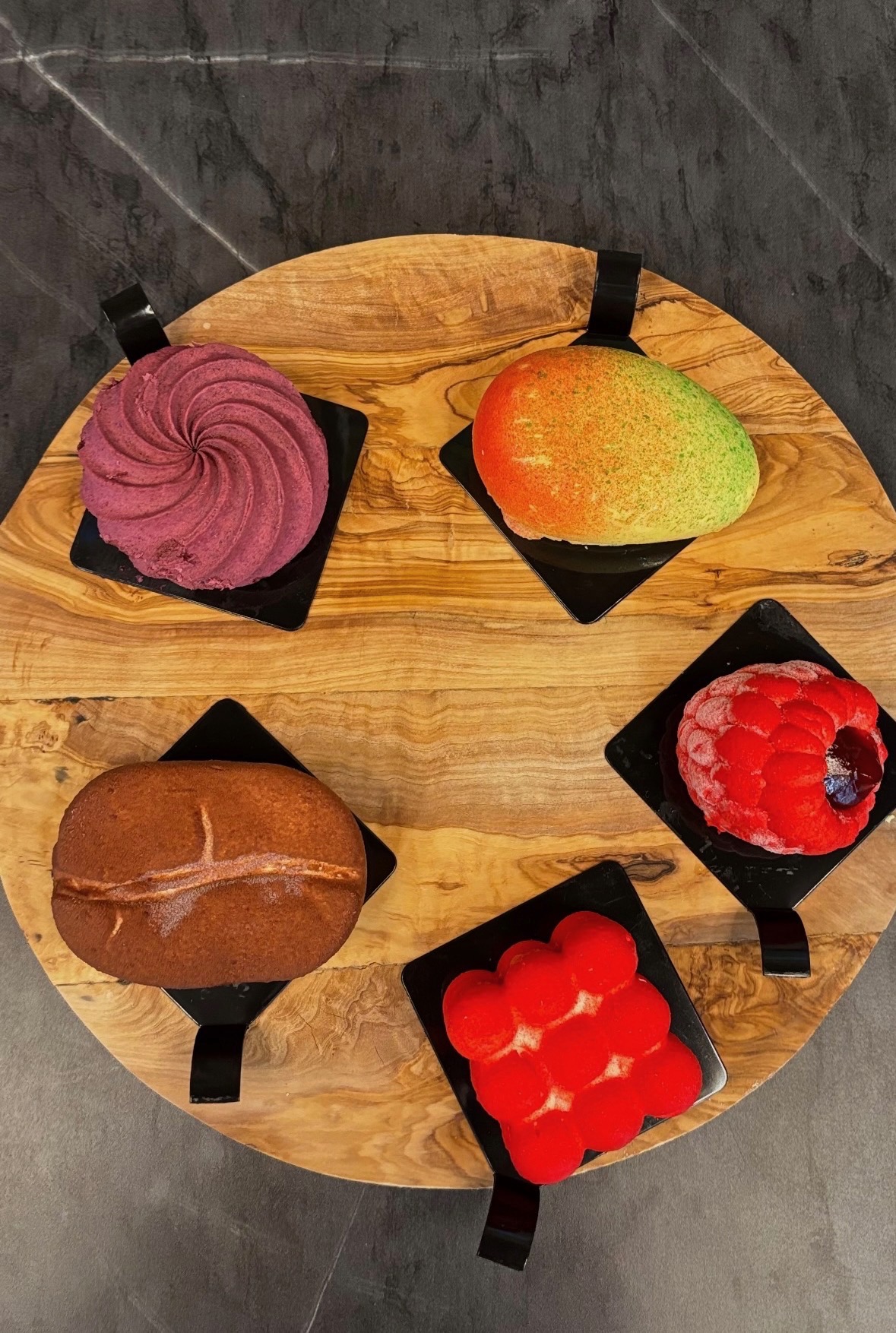 Handcrafted artisan pastries on olive wood board